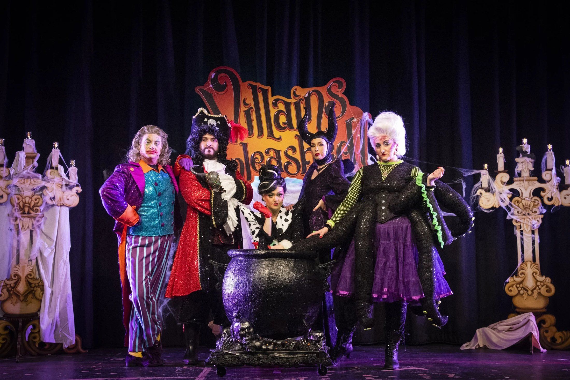 The Villains Unleashed! cast around a cauldron on stage